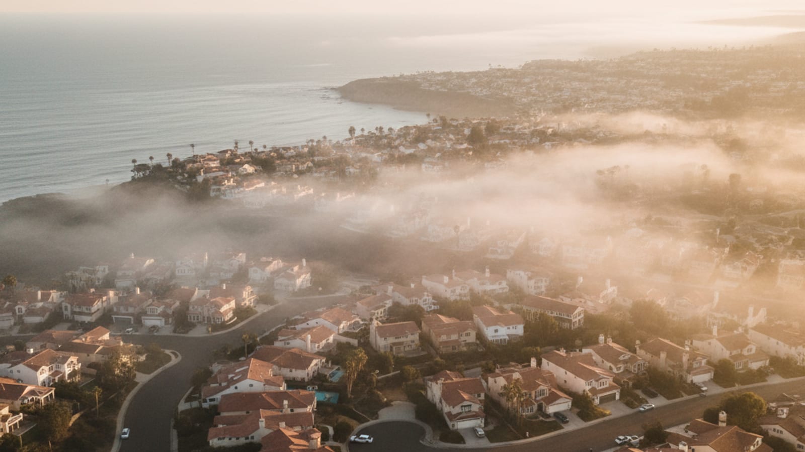 Marine layer rolling in over coastal San Diego homes near the Pacific